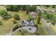 Birds eye view showing this white home nestled in lush trees and a manicured lawn at 70 S Patterson St, Coats, NC 27521