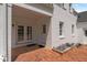 Brick patio of white brick home featuring a double door and single door entrance at 70 S Patterson St, Coats, NC 27521