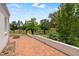 Large brick patio featuring a fire pit and views of the lawn and trees at 70 S Patterson St, Coats, NC 27521