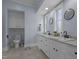 Bathroom with double sinks, granite countertops, and two vanity mirrors at 70 S Patterson St, Coats, NC 27521