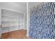 Bathroom featuring a patterned shower curtain and a shelved closet space at 70 S Patterson St, Coats, NC 27521