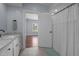 Bright bathroom with white cabinets, granite countertops, and a shower with white curtain at 70 S Patterson St, Coats, NC 27521