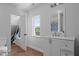 Bright bathroom with a modern vanity, window, and view into the closet at 70 S Patterson St, Coats, NC 27521