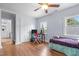 Bedroom featuring hardwood floors, an ensuite bathroom, and large windows for natural light at 70 S Patterson St, Coats, NC 27521