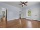 Light-filled bedroom featuring hardwood floors, blue walls, and double closets at 70 S Patterson St, Coats, NC 27521