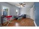 Cozy bedroom featuring hardwood floors, natural light, and a ceiling fan at 70 S Patterson St, Coats, NC 27521