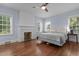 Bedroom with hardwood floors, a fireplace, and three windows for natural light at 70 S Patterson St, Coats, NC 27521