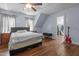 Spacious bedroom with hardwood floors, fan, and large windows for natural lighting at 70 S Patterson St, Coats, NC 27521