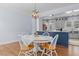 View of the dining room into the kitchen with modern lighting, finishes, and stainless appliances at 70 S Patterson St, Coats, NC 27521