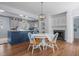 Open floor plan of dining room and kitchen with modern lighting, finishes, and stainless appliances at 70 S Patterson St, Coats, NC 27521