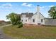 View of the bright white painted house with a well maintained lawn and brick patio at 70 S Patterson St, Coats, NC 27521