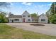 Charming exterior view of a large, white home featuring a red front door and well-maintained landscaping at 70 S Patterson St, Coats, NC 27521