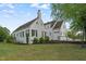 Exterior view showing a beautiful white painted brick house with manicured garden at 70 S Patterson St, Coats, NC 27521