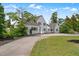 Exterior view of a large white house with a circular driveway, surrounded by green lawns and mature trees at 70 S Patterson St, Coats, NC 27521