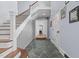 Foyer with slate flooring, a wooden staircase, and white trim, creating a welcoming entrance at 70 S Patterson St, Coats, NC 27521