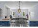 Kitchen with white walls, island with range and oven, and dining area at 70 S Patterson St, Coats, NC 27521
