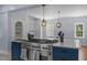 Island with range and oven, blue cabinets and white countertops and hanging pendant lights at 70 S Patterson St, Coats, NC 27521