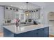Gray cabinets and large kitchen island with quartz countertops and stainless appliances at 70 S Patterson St, Coats, NC 27521