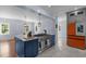 Kitchen island with range and oven, orange refrigerator and dining area at 70 S Patterson St, Coats, NC 27521