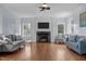 Bright living room featuring hardwood floors, a marble fireplace, and abundant natural light at 70 S Patterson St, Coats, NC 27521