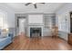 Living room features hardwood floors, a brick fireplace, built in bookshelves and a rocking chair at 70 S Patterson St, Coats, NC 27521