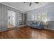 Living room with hardwood floors, built-in bookshelves, and a comfortable seating area at 70 S Patterson St, Coats, NC 27521