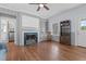 Cozy living room featuring hardwood floors, a fireplace, and built-in bookshelves for a warm atmosphere at 70 S Patterson St, Coats, NC 27521