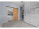 Well lit walk in pantry with wood sliding door and built in storage at 70 S Patterson St, Coats, NC 27521