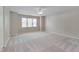 Spacious bedroom with carpet flooring, neutral walls, ceiling fan, and multiple windows providing natural light at 7024 Beaverwood Dr, Raleigh, NC 27616