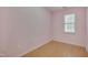 Bright bedroom featuring hardwood floors and a window with natural light, creating a cozy and inviting atmosphere at 7024 Beaverwood Dr, Raleigh, NC 27616