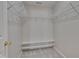 Walk-in closet featuring white shelving and carpet flooring, providing organized storage solutions at 7024 Beaverwood Dr, Raleigh, NC 27616