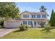 Charming two-story home with blue shutters and a well-manicured lawn, offering classic curb appeal at 7024 Beaverwood Dr, Raleigh, NC 27616