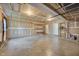 Spacious garage with concrete floor, exposed ceiling, and ample storage space for vehicles and equipment at 7024 Beaverwood Dr, Raleigh, NC 27616