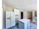 Bright kitchen featuring white cabinets, an island, and modern appliances at 7024 Beaverwood Dr, Raleigh, NC 27616
