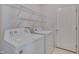 Practical laundry room with washer, dryer, and shelving at 7024 Beaverwood Dr, Raleigh, NC 27616