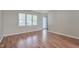 Cozy living room featuring wood floors and access to the exterior at 7024 Beaverwood Dr, Raleigh, NC 27616