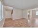 Open concept living room with staircase, wood floors, and view of the kitchen at 7024 Beaverwood Dr, Raleigh, NC 27616