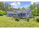 Charming home exterior showcasing well-maintained landscaping and a serene, wooded setting at 741 Sinai Cir, Hillsborough, NC 27278