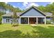 Charming blue home featuring a well-manicured lawn and a welcoming front porch with a striking wood front door at 741 Sinai Cir, Hillsborough, NC 27278