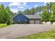 View of home showing side entrance and spacious 2-car garage, framed by a neatly paved driveway and manicured landscaping at 741 Sinai Cir, Hillsborough, NC 27278