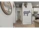 Hallway with art and cow themed decor that leads to the kitchen with stainless steel appliances at 741 Sinai Cir, Hillsborough, NC 27278