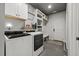 Well-lit laundry area features modern washer and dryer, storage cabinets and shelves, and easy access to the exterior at 741 Sinai Cir, Hillsborough, NC 27278