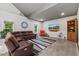 Open-concept living area featuring a comfortable leather sectional and a large flat-screen TV for relaxation and entertainment at 741 Sinai Cir, Hillsborough, NC 27278