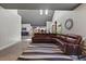 Bright living room featuring an oversized leather couch and stylish gray and white rug at 741 Sinai Cir, Hillsborough, NC 27278