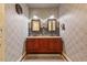 Double vanity bathroom with framed mirrors, ample storage, and stylish wallpaper at 741 Sinai Cir, Hillsborough, NC 27278