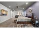 Spacious main bedroom with a king bed, concrete floors, and a sitting area in a well-lit room at 741 Sinai Cir, Hillsborough, NC 27278