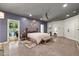 Well lit primary bedroom boasting concrete floors, a king bed, sitting area, and easy access to the outdoors at 741 Sinai Cir, Hillsborough, NC 27278