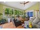 Sun-drenched sun room with large windows, comfortable seating, and vibrant indoor plants at 741 Sinai Cir, Hillsborough, NC 27278