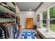 Organized walk-in closet with ample storage, custom shelving and window seat offering natural light at 741 Sinai Cir, Hillsborough, NC 27278