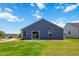 Rear view of the house with a sliding glass door leading to a small patio and a lawn at 75 Springwood Ln, Franklinton, NC 27525